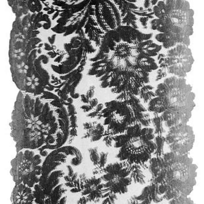 Black floral lace panel with a scalloped edge